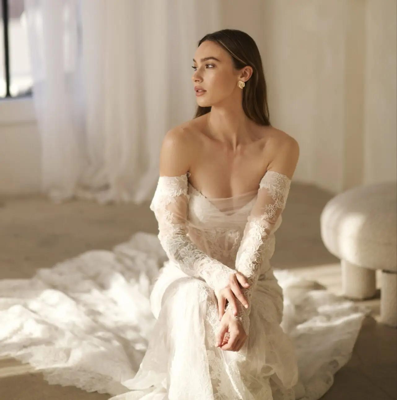 Model wearing a white gown by Martina Liana