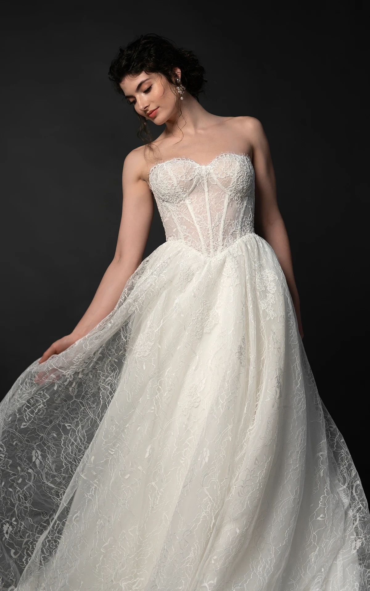 Model wearing a white gown by Martina Liana